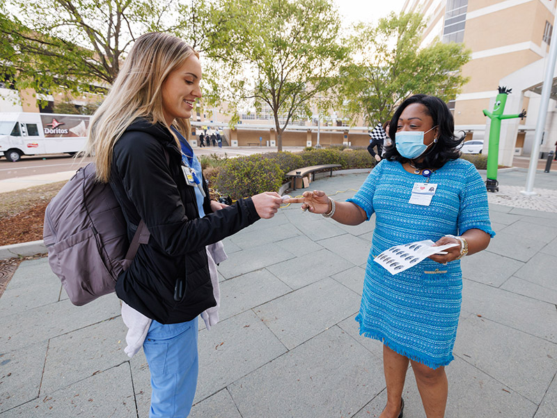 Registered nurse Ana Grace Holder receives a Patient Safety Week sticker from Adult Hospitals COO Kimberlee Daniels.